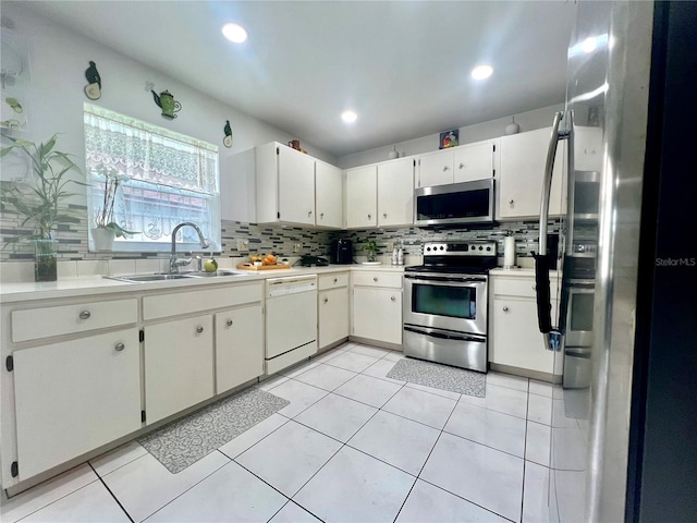 2376 Flamingo Lakes Dr, Kissimmee, FL 34743 - kitchen with stainless steel appliances, a sink, decorative backsplash, light countertops, and recessed lighting