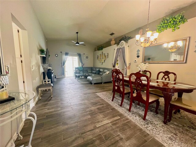 2376 Flamingo Lakes Dr, Kissimmee, FL 34743 - dining area featuring dark wood-style floors, a chandelier, lofted ceiling, and a ceiling fan