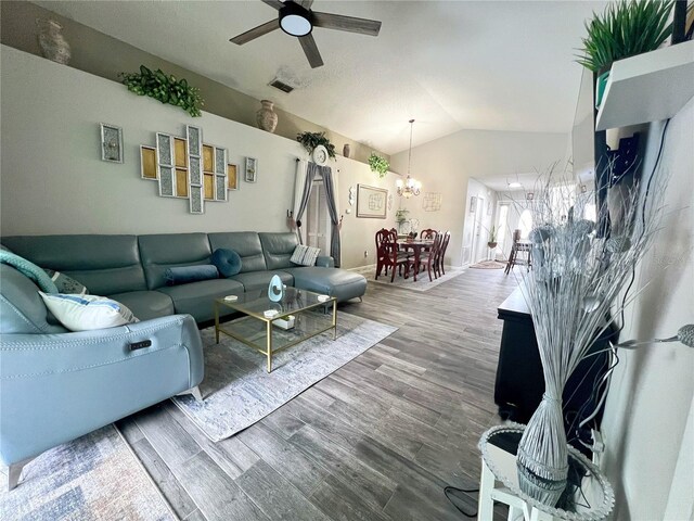 2376 Flamingo Lakes Dr, Kissimmee, FL 34743 - living area featuring lofted ceiling, wood finished floors, ceiling fan, a chandelier, and baseboards