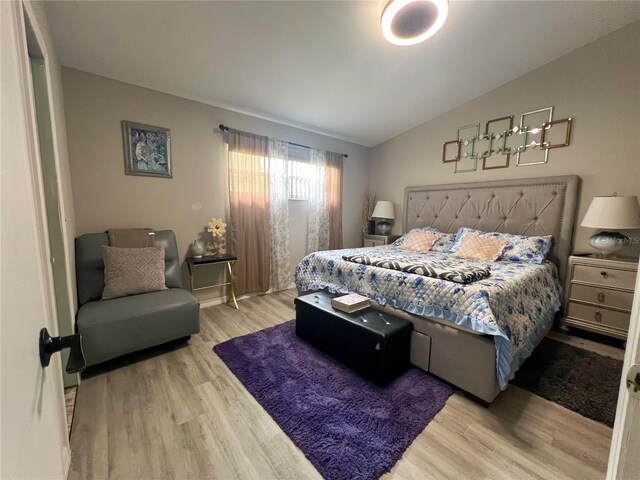 2376 Flamingo Lakes Dr, Kissimmee, FL 34743 - bedroom featuring light wood-style floors and vaulted ceiling