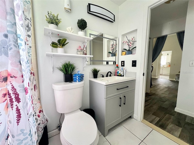 2376 Flamingo Lakes Dr, Kissimmee, FL 34743 - full bathroom with vanity, toilet, baseboards, tile patterned floors, and curtained shower