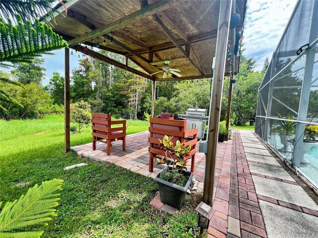2376 Flamingo Lakes Dr, Kissimmee, FL 34743 - view of patio with ceiling fan, grilling area, glass enclosure, and a pool