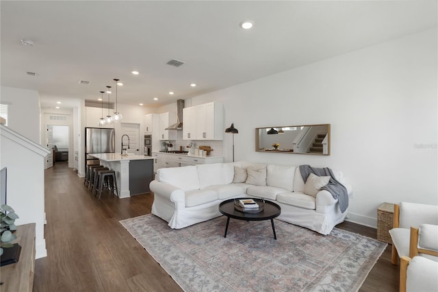 15408 Lebeau Loop, Winter Garden, FL 34787 - living area featuring stairs, dark wood finished floors, recessed lighting, and baseboards
