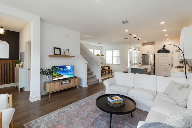 15408 Lebeau Loop, Winter Garden, FL 34787 - living area with stairs, dark wood-style floors, recessed lighting, and baseboards