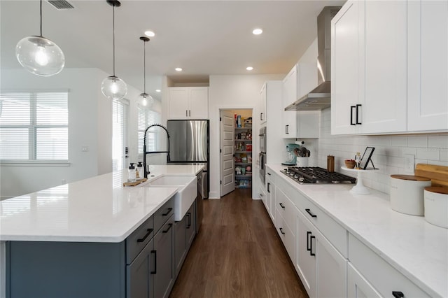 15408 Lebeau Loop, Winter Garden, FL 34787 - kitchen with gray cabinetry, wall chimney range hood, dark wood-style floors, backsplash, and light countertops