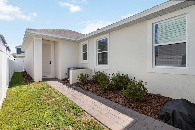 15408 Lebeau Loop, Winter Garden, FL 34787 - view of exterior entry featuring stucco siding and central AC unit
