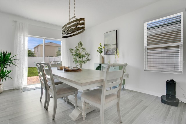 2834 Common Crane Ct, Saint Cloud, FL 34773 - dining area with a chandelier, light wood-type flooring, and baseboards