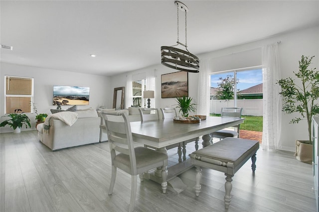 2834 Common Crane Ct, Saint Cloud, FL 34773 - dining room with plenty of natural light, light wood-type flooring, recessed lighting, baseboards, and a chandelier
