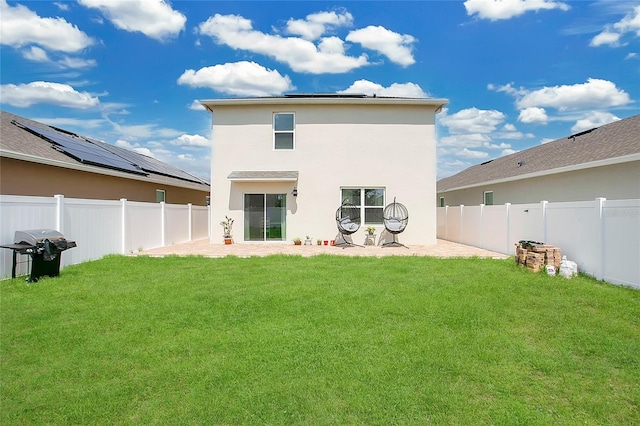 2834 Common Crane Ct, Saint Cloud, FL 34773 - rear view of property with roof mounted solar panels, a patio area, and stucco siding