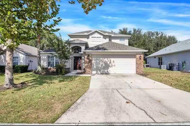 traditional-style home with an attached garage, a front yard, brick siding, and concrete driveway