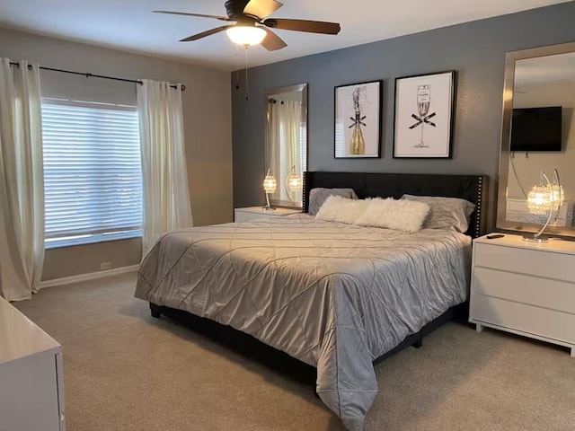 carpeted bedroom featuring baseboards and ceiling fan