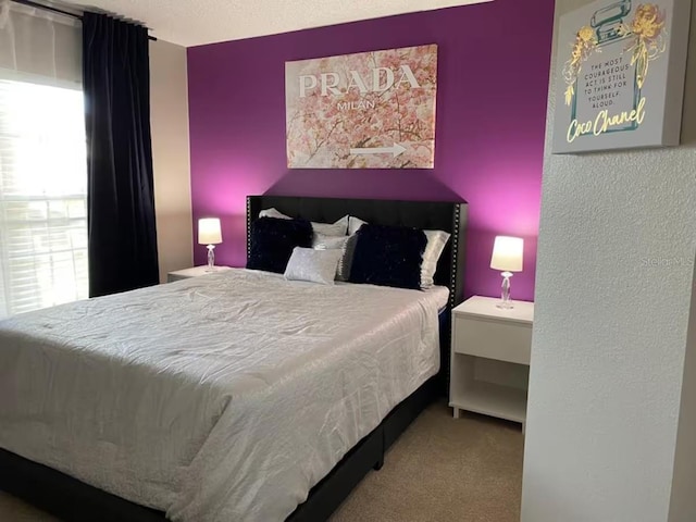 bedroom featuring carpet and a textured wall