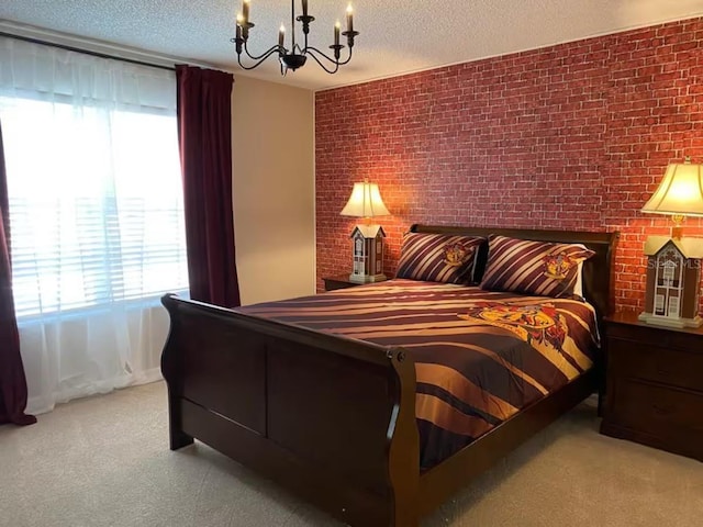 carpeted bedroom with a chandelier, a textured ceiling, and brick wall