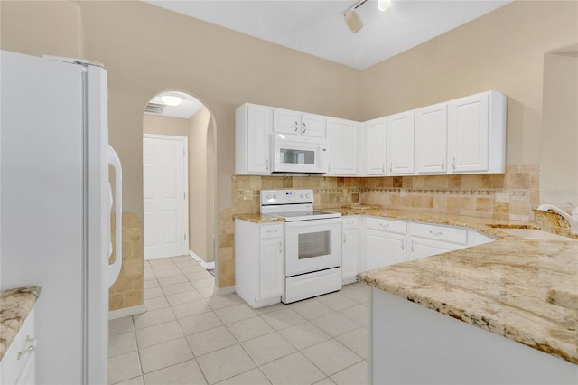 922 Hatteras Ave, Minneola, FL 34715 - kitchen with white appliances, a sink, light stone countertops, and tasteful backsplash