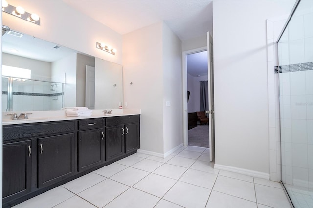 9038 Sunshine Ridge Loop, Kissimmee, FL 34747 - full bath featuring double vanity, a tile shower, tile patterned flooring, and baseboards