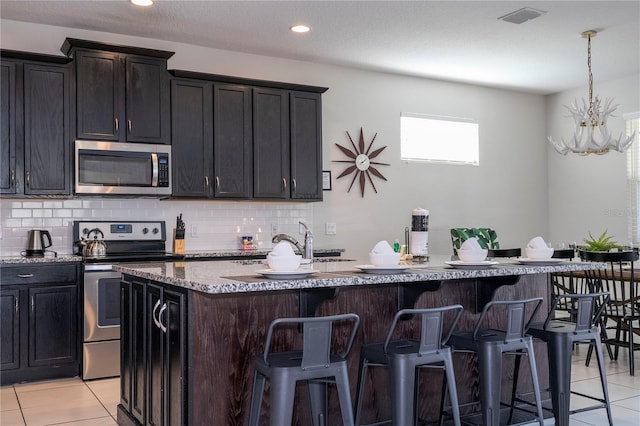 9038 Sunshine Ridge Loop, Kissimmee, FL 34747 - kitchen featuring stainless steel appliances, light tile patterned floors, backsplash, and recessed lighting