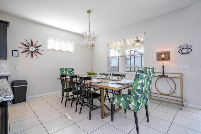 9038 Sunshine Ridge Loop, Kissimmee, FL 34747 - dining room featuring healthy amount of natural light, a chandelier, light tile patterned floors, and baseboards