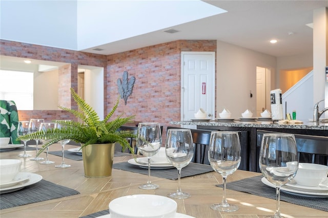 9038 Sunshine Ridge Loop, Kissimmee, FL 34747 - dining space featuring brick wall and recessed lighting