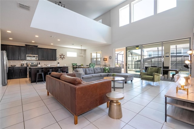 9038 Sunshine Ridge Loop, Kissimmee, FL 34747 - living area with plenty of natural light, light tile patterned floors, recessed lighting, and a high ceiling