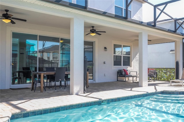 9038 Sunshine Ridge Loop, Kissimmee, FL 34747 - outdoor pool featuring ceiling fan, a patio area, glass enclosure, and outdoor dining area