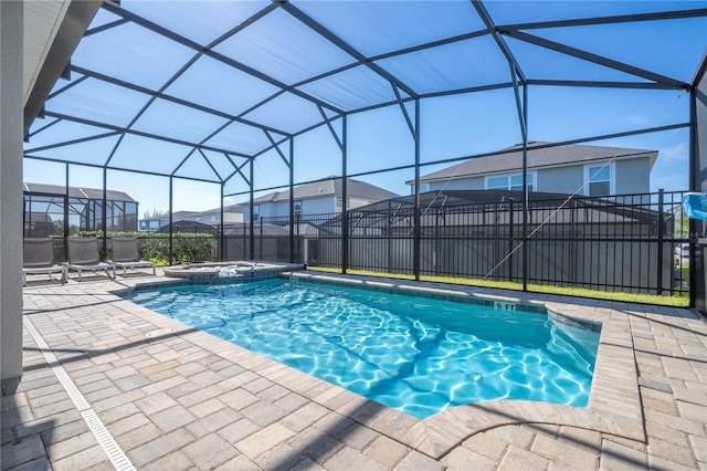 9038 Sunshine Ridge Loop, Kissimmee, FL 34747 - view of swimming pool with a patio area, a pool with connected hot tub, and glass enclosure