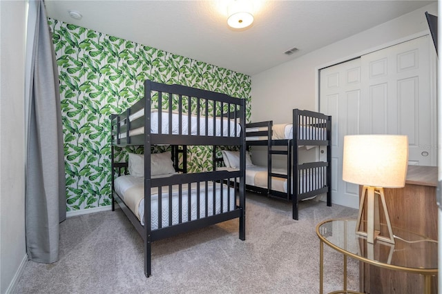 9038 Sunshine Ridge Loop, Kissimmee, FL 34747 - bedroom featuring an accent wall, carpet, baseboards, and wallpapered walls