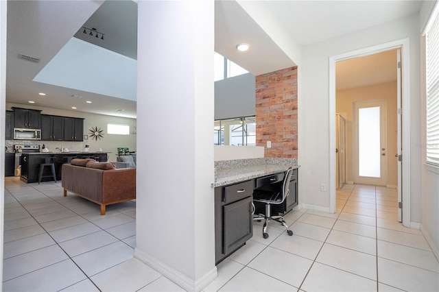 9038 Sunshine Ridge Loop, Kissimmee, FL 34747 - office space featuring light tile patterned flooring, baseboards, built in study area, and recessed lighting