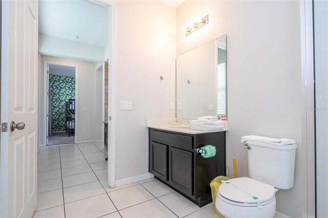 9038 Sunshine Ridge Loop, Kissimmee, FL 34747 - bathroom featuring vanity, tile patterned flooring, toilet, and baseboards