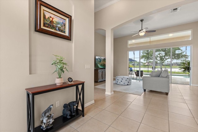 14174 Islamorada Dr, Orlando, FL 32837 - hall with light tile patterned flooring, baseboards, and arched walkways