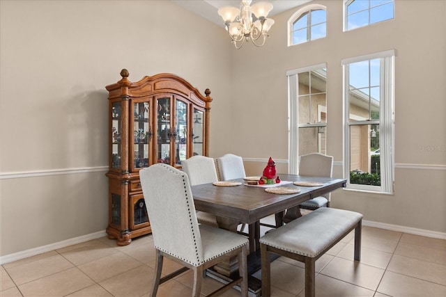 14174 Islamorada Dr, Orlando, FL 32837 - dining room featuring a chandelier, light tile patterned floors, baseboards, and a high ceiling