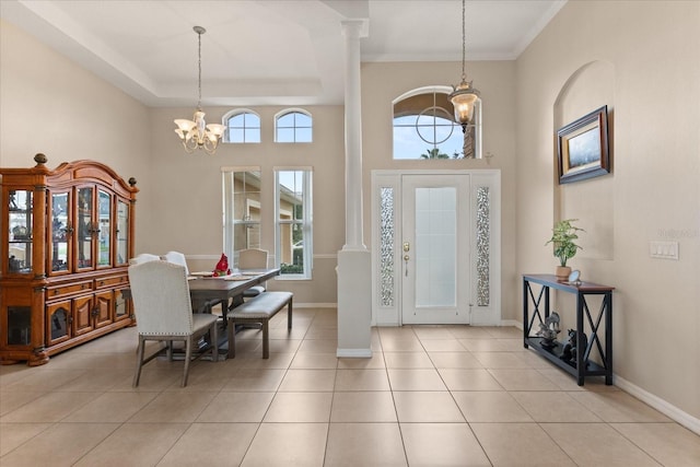 14174 Islamorada Dr, Orlando, FL 32837 - entrance foyer featuring a chandelier, ornate columns, light tile patterned flooring, baseboards, and a towering ceiling
