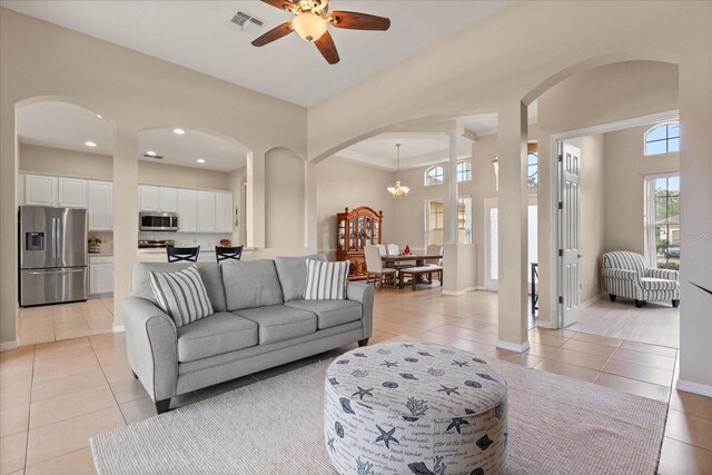 14174 Islamorada Dr, Orlando, FL 32837 - living area featuring arched walkways, plenty of natural light, a ceiling fan, light tile patterned flooring, and recessed lighting