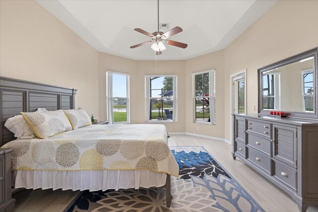 14174 Islamorada Dr, Orlando, FL 32837 - bedroom with light wood-style flooring, multiple windows, baseboards, and a ceiling fan