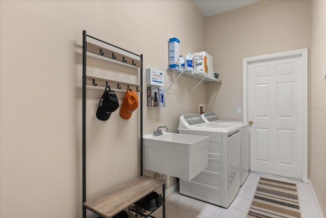 14174 Islamorada Dr, Orlando, FL 32837 - washroom with independent washer and dryer and light tile patterned flooring