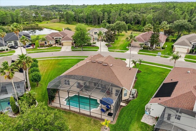 14174 Islamorada Dr, Orlando, FL 32837 - aerial perspective of suburban area with a large body of water, a pool, and a heavily wooded area