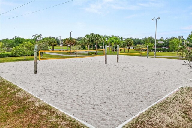 14174 Islamorada Dr, Orlando, FL 32837 - view of community featuring volleyball court, a yard, and view of wooded area