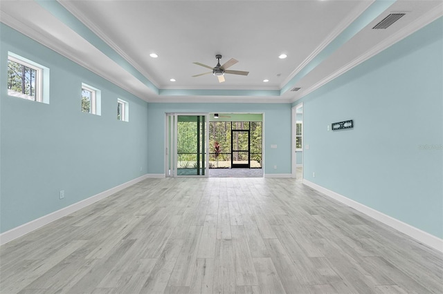 867 Bama Breeze Dr, Daytona Beach, FL 32124 - spare room with a raised ceiling, ceiling fan, plenty of natural light, crown molding, and light wood finished floors