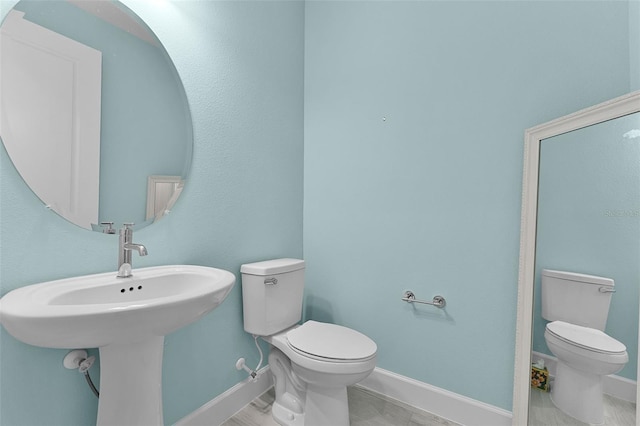 867 Bama Breeze Dr, Daytona Beach, FL 32124 - half bathroom with toilet, baseboards, and wood finished floors