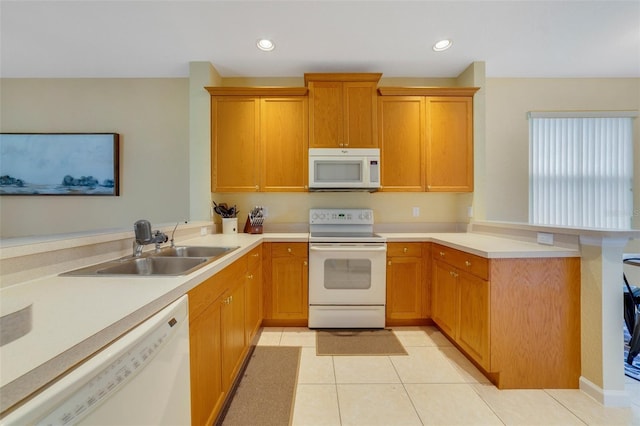 2956 White Cedar Cir, Kissimmee, FL 34741 - kitchen featuring white appliances, a peninsula, a sink, light countertops, and light tile patterned flooring