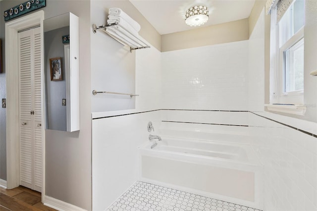 full bath with a garden tub and a closet