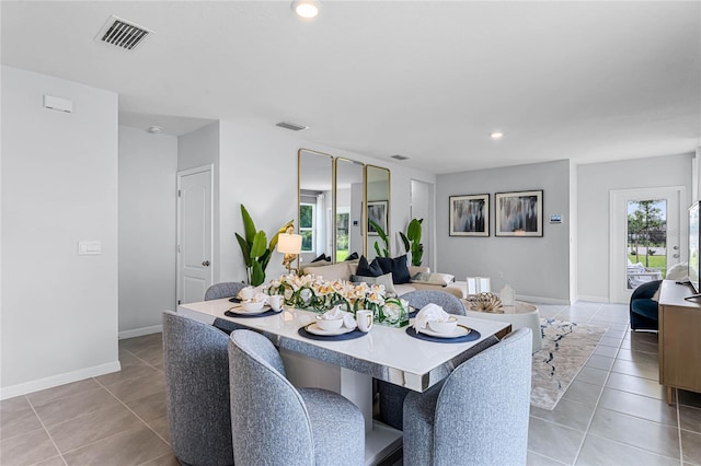dining area with light tile patterned floors, baseboards, and recessed lighting