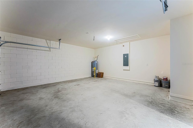 garage with electric water heater, electric panel, and concrete block wall