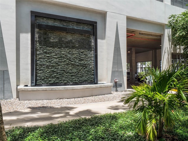 property entrance with stone siding and stucco siding
