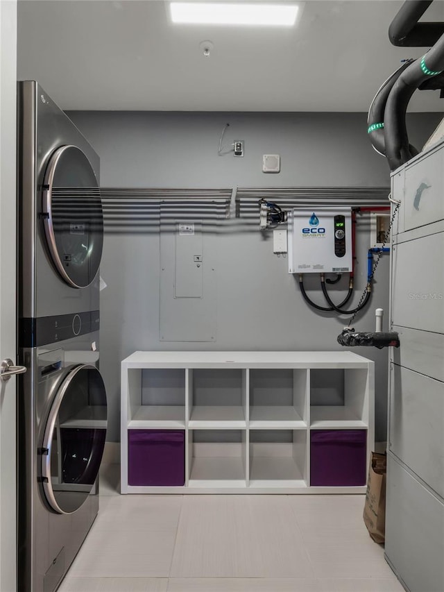 laundry room featuring stacked washer / drying machine