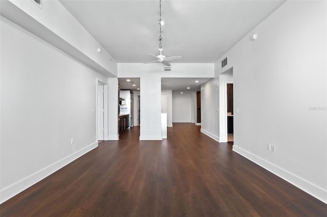 unfurnished living room featuring a ceiling fan, dark wood-style floors, and baseboards