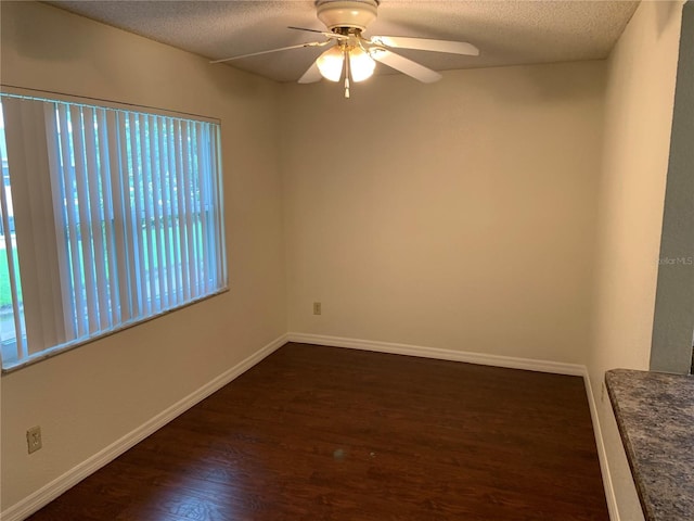 9926 Turf Way Unit 8, Orlando, FL 32837 - empty room featuring a textured ceiling, dark wood-style floors, a ceiling fan, and baseboards