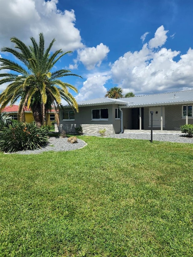 5325 Cocoa Ct, Cape Coral, FL 33904 - rear view of house with a lawn and stucco siding
