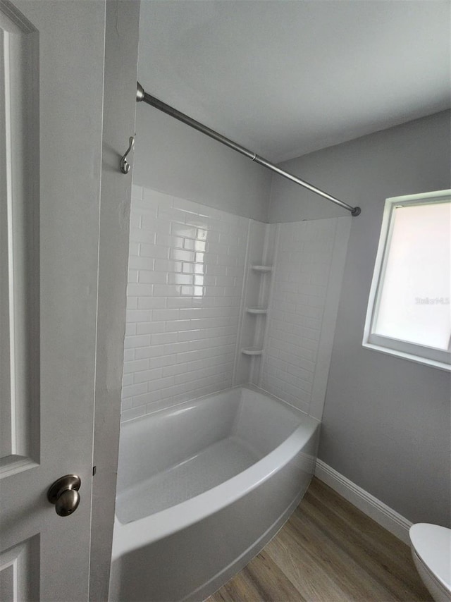 5325 Cocoa Ct, Cape Coral, FL 33904 - bathroom with wood finished floors, baseboards, toilet, and shower / washtub combination