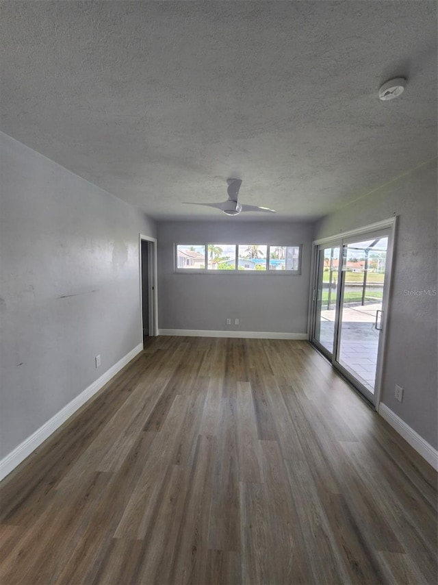 5325 Cocoa Ct, Cape Coral, FL 33904 - unfurnished room with wood finished floors, a textured ceiling, baseboards, a smoke detector, and ceiling fan