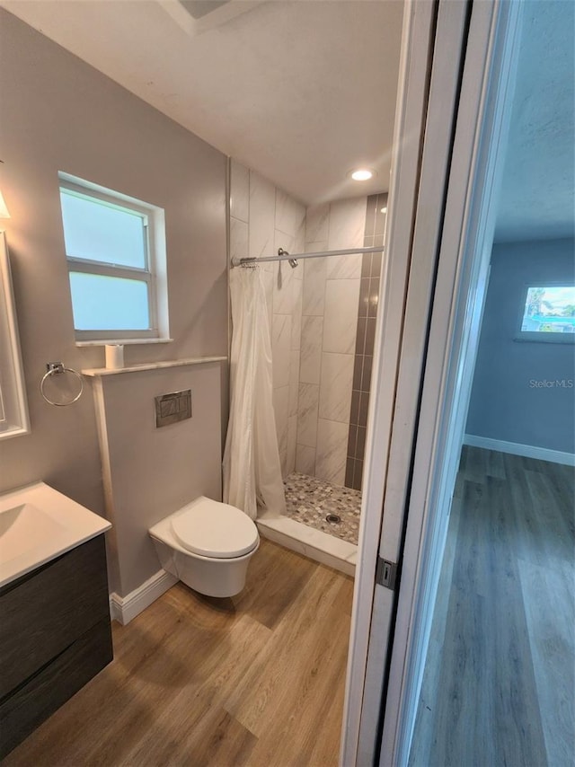 5325 Cocoa Ct, Cape Coral, FL 33904 - bathroom featuring tiled shower, toilet, vanity, and wood finished floors